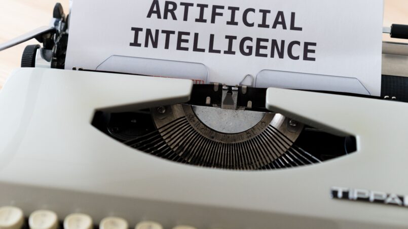 A close-up of a typewriter showcasing 'ARTIFICIAL INTELLIGENCE' on paper.